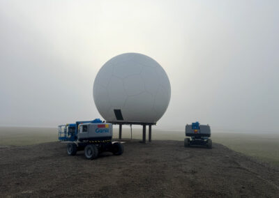 30ft 9.14m rigid sandwich radome installed on steel platform. Foggy conditions. Equipment used for installation in lower portion of the photo.